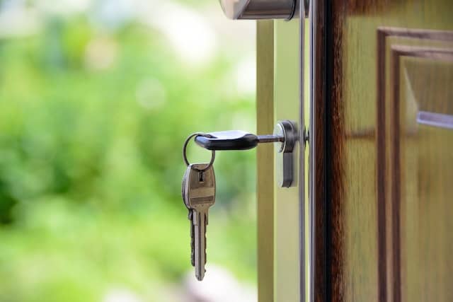 an open door with keys in the lock