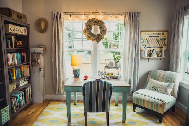 a desk facing a large window