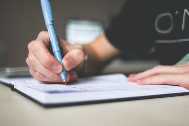 a person writing in a notebook