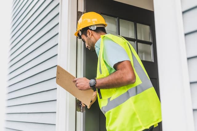 someone inspecting a door frame