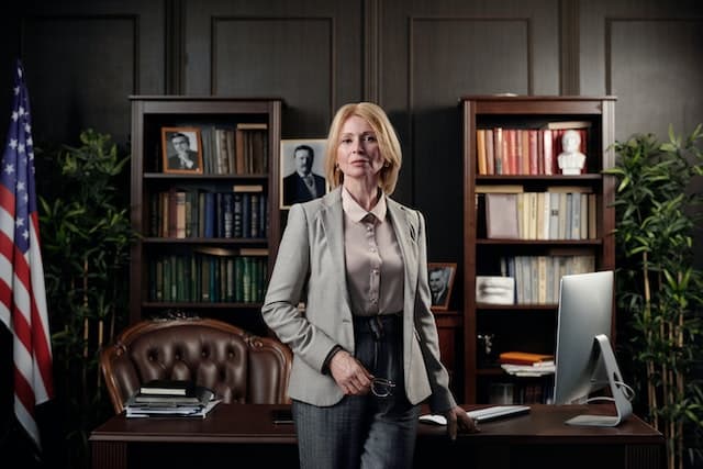 a lawyer standing in front of a  desk in their office