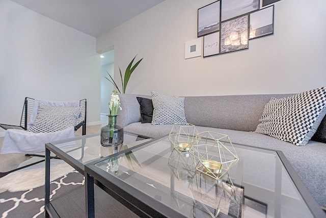 a living room with gray accents and a large sofa