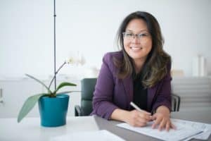 person in a purple suit in an office