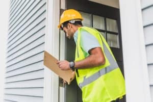 person inspecting doorframe