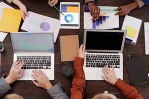 a group of people on laptops and looking at graphs
