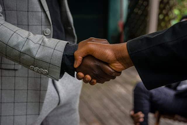 two-people-shaking-hands-in-a-professional-setting